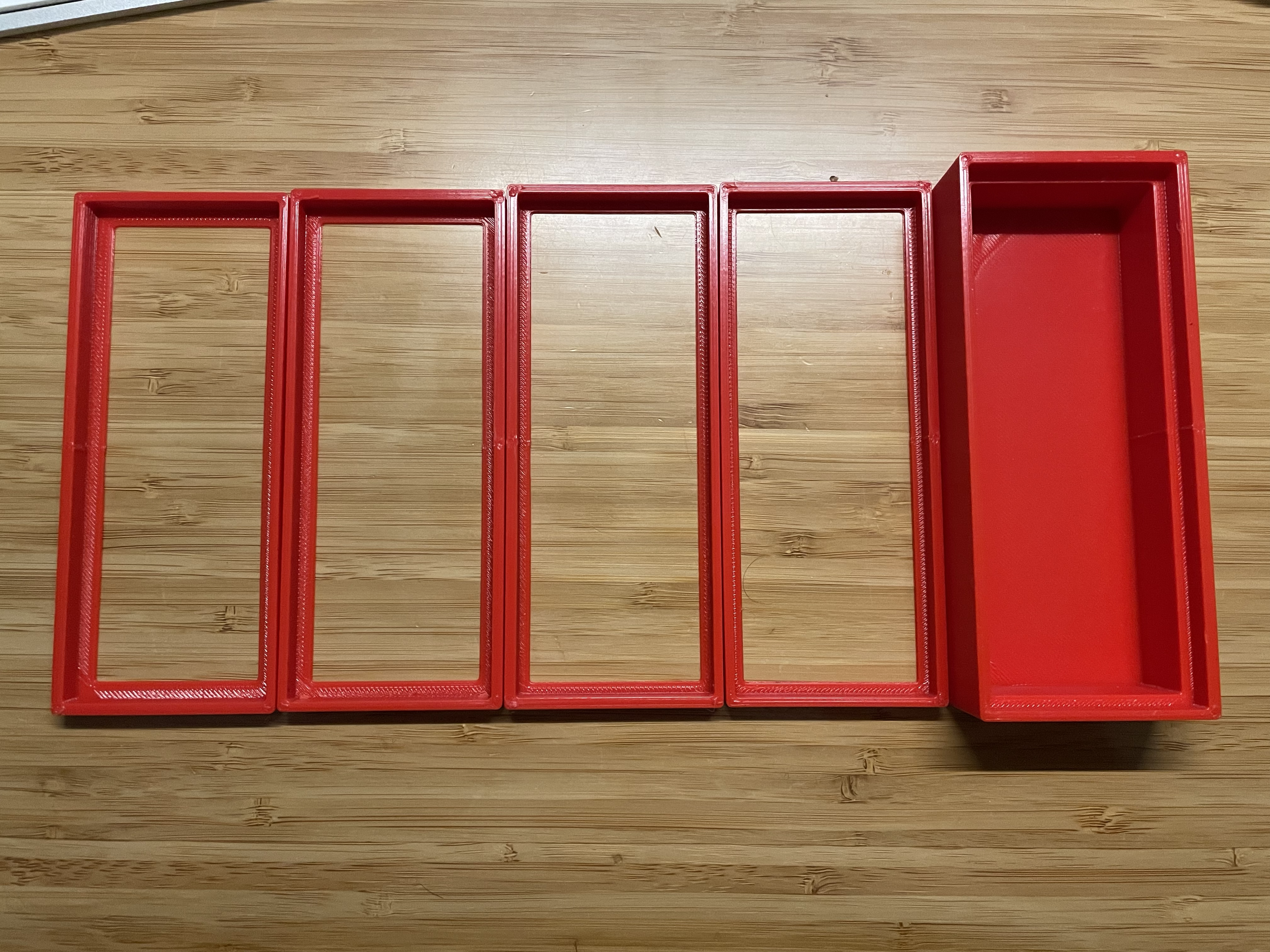 Four rectangular red rectangles represent each of the test prints before I printed the final box on the far right.
